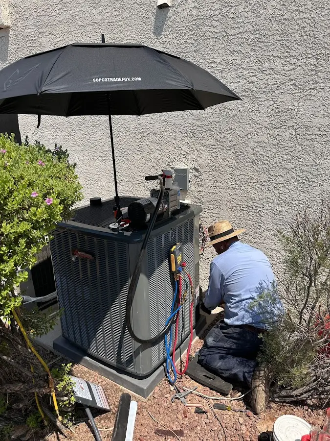 HVAC technician performing outdoor AC maintenance in Chalmette